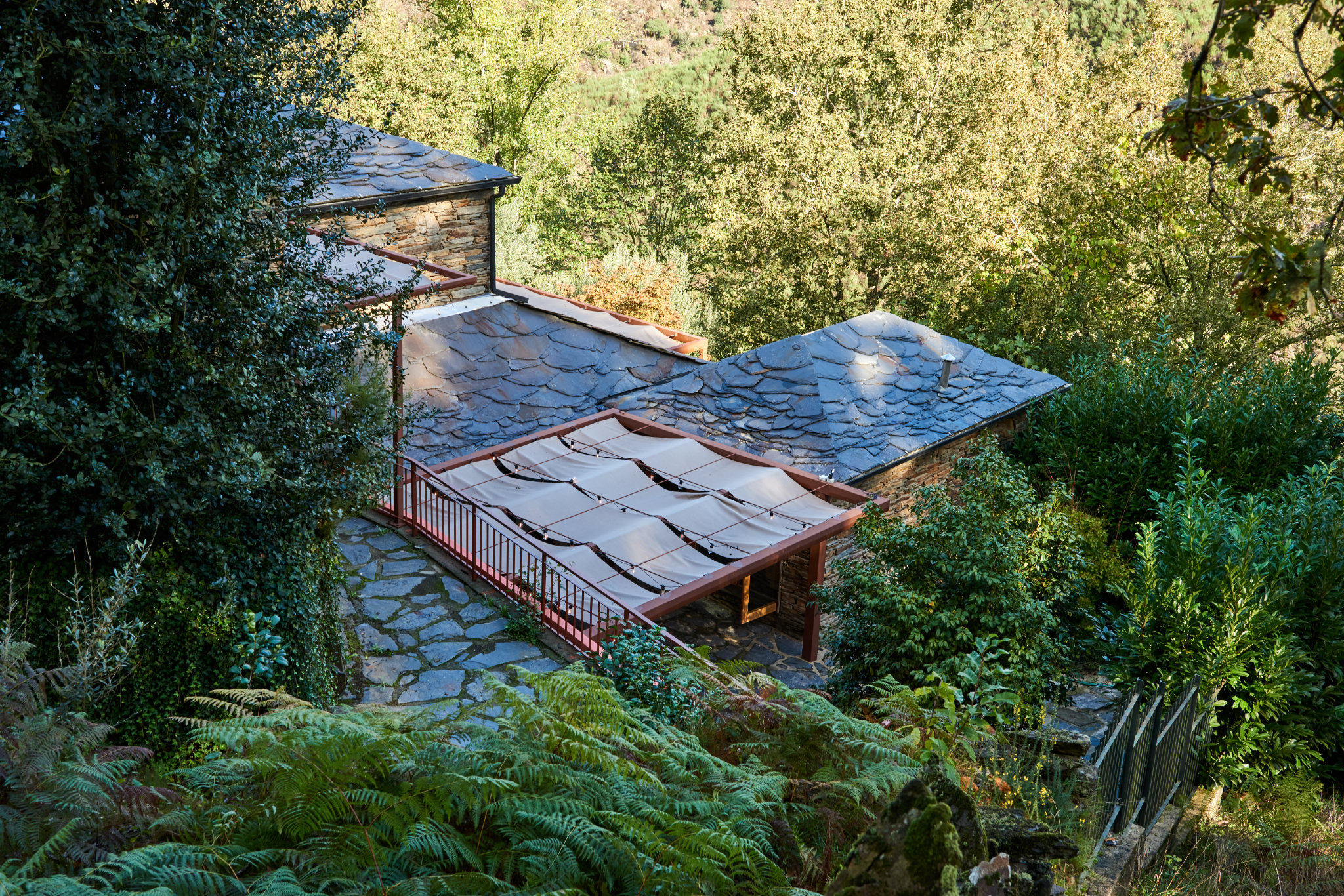 Eco-friendly renovation of a 30-year-old schist house in northern Portugal using sustainable materials.