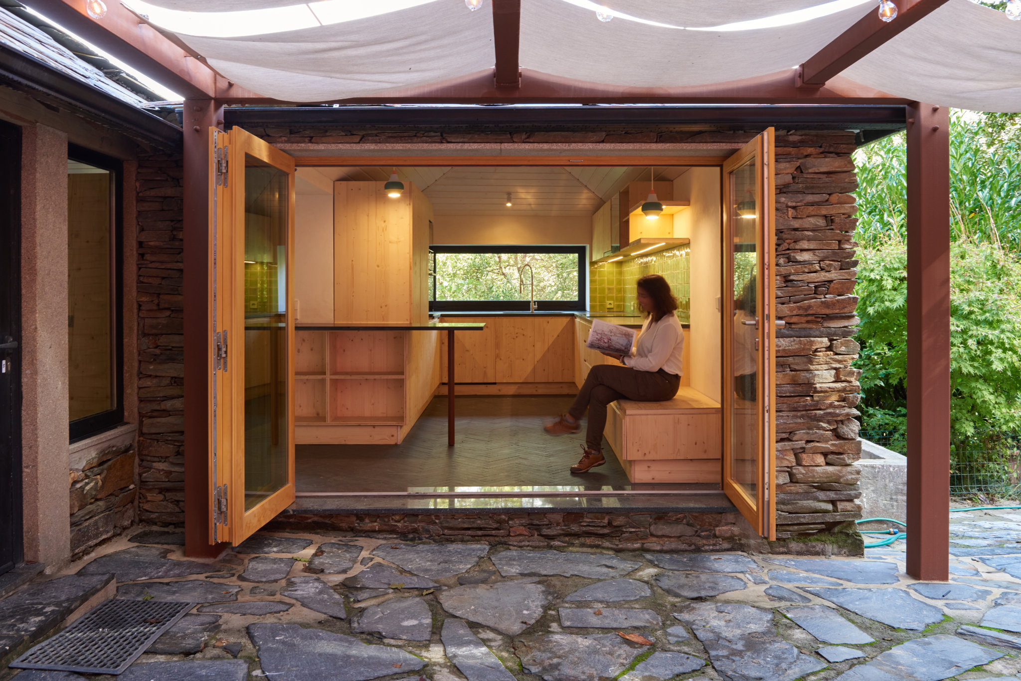 Eco-friendly renovation of a 30-year-old schist house in northern Portugal using sustainable materials.