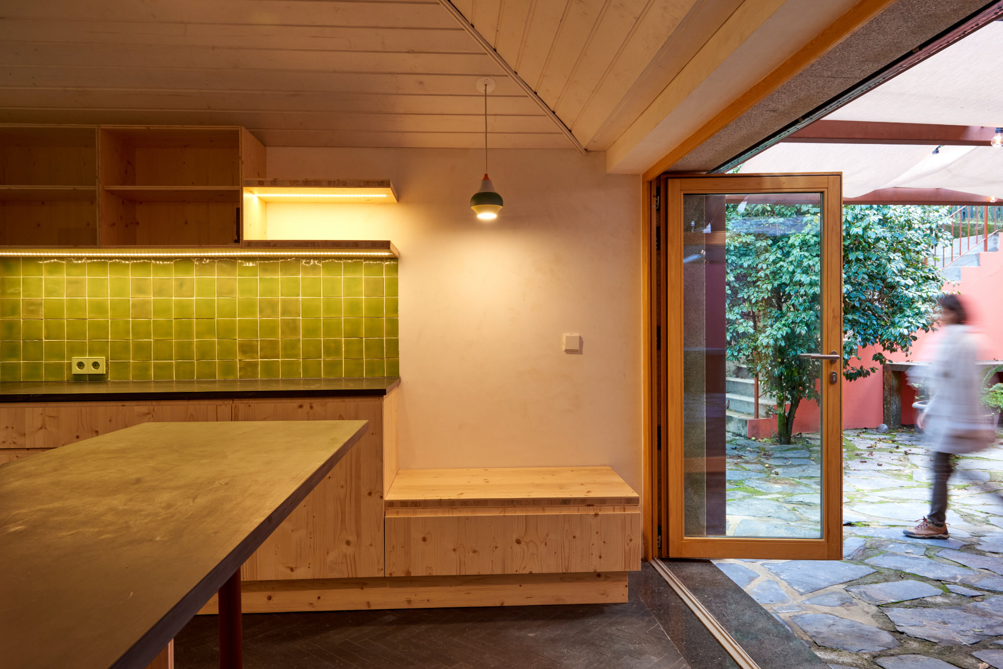 Eco-friendly renovation of a 30-year-old schist house in northern Portugal using sustainable materials.