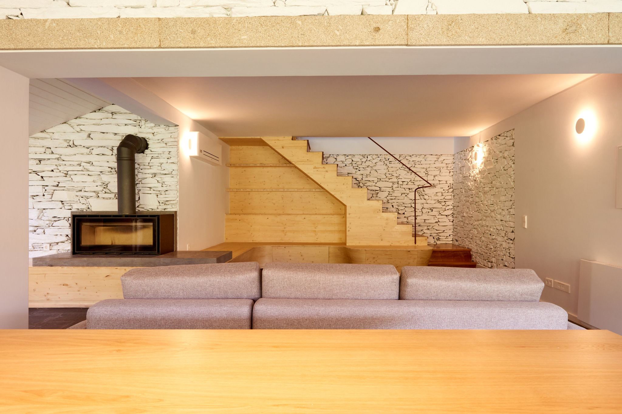 Eco-friendly renovation of a 30-year-old schist house in northern Portugal using sustainable materials.