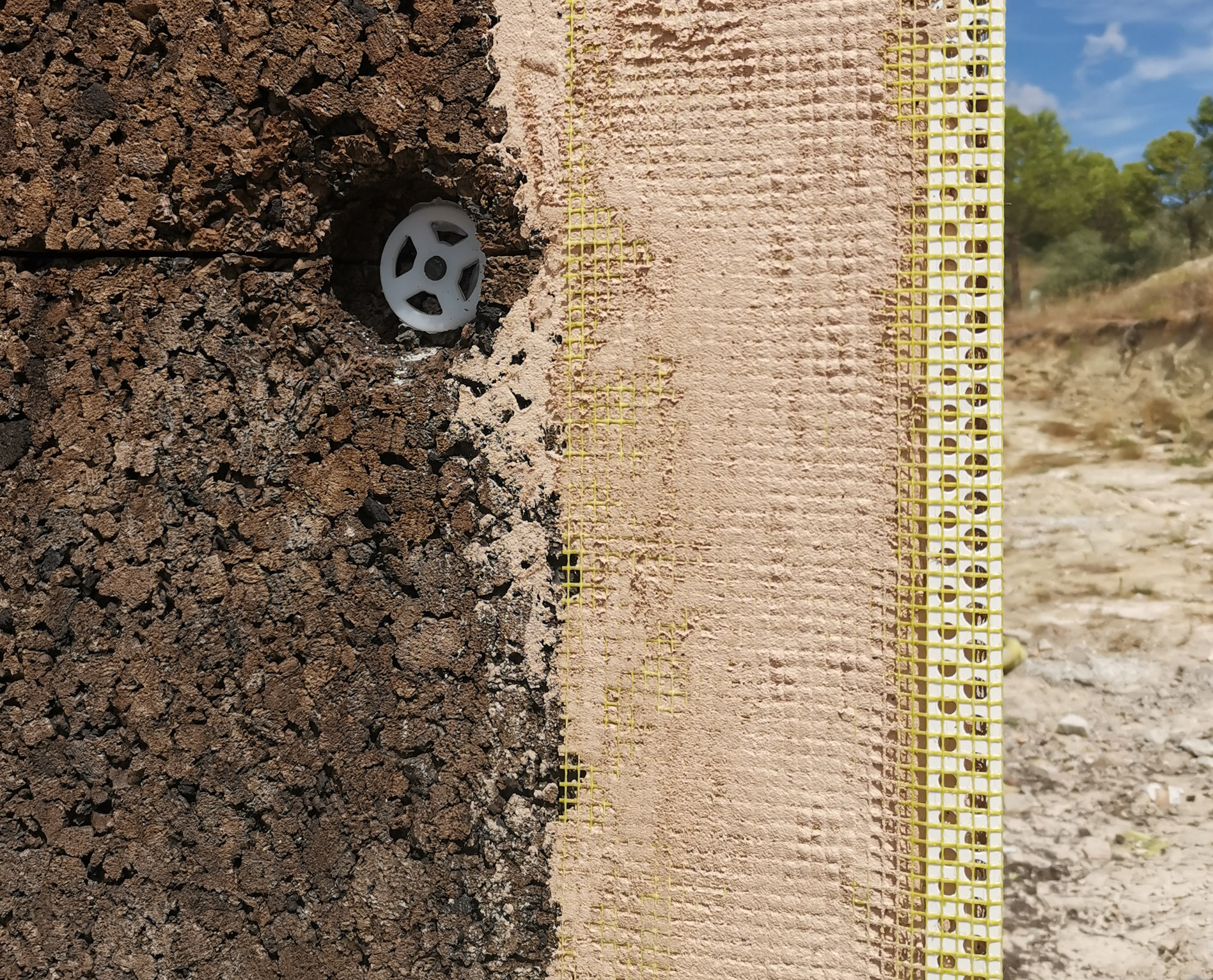 Construction detail with cork insulation and lime plaster finish — sustainable architecture in Portugal.