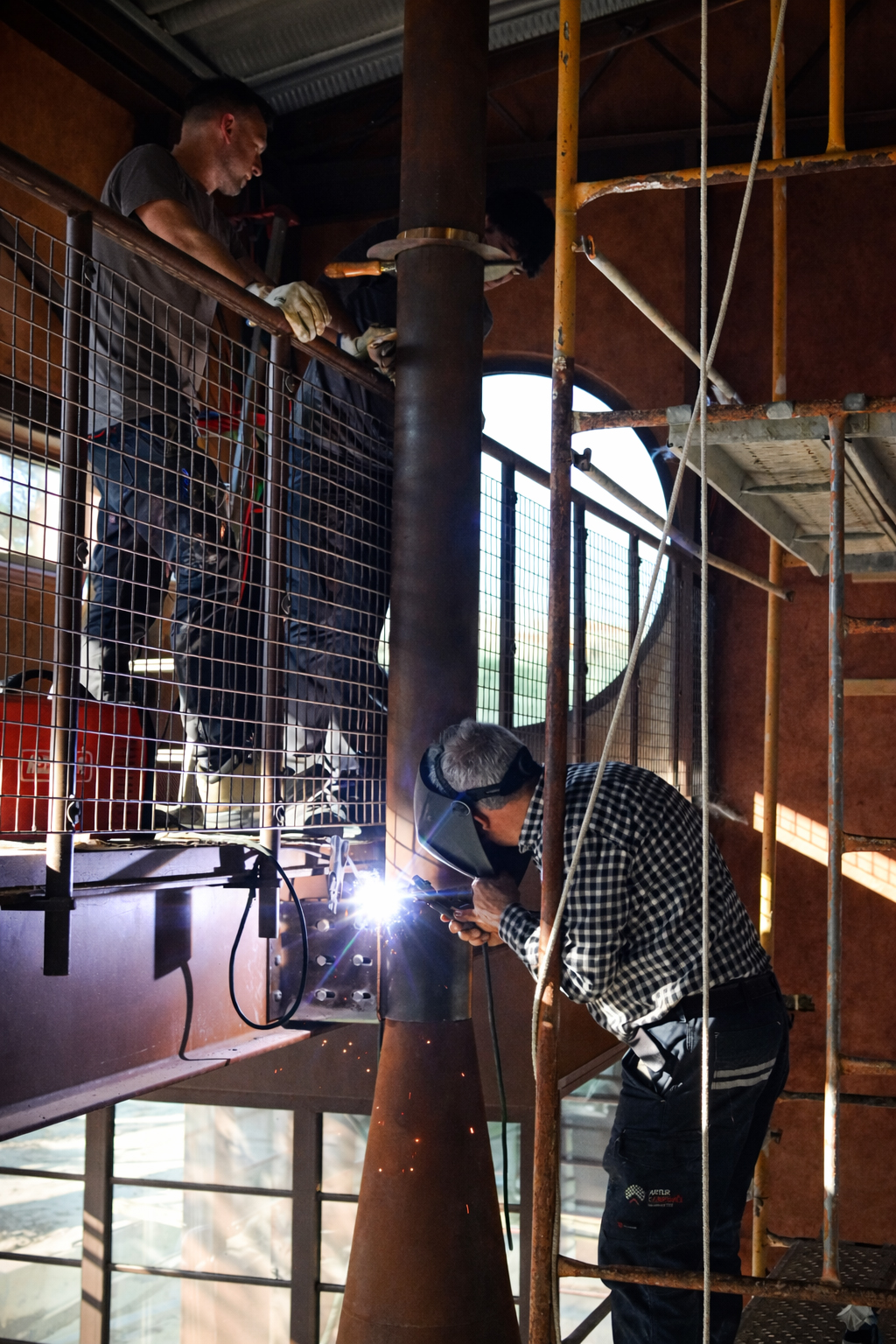 On-site welding of suspended steel fireplace structure, Project Outeiro, CAS Studio