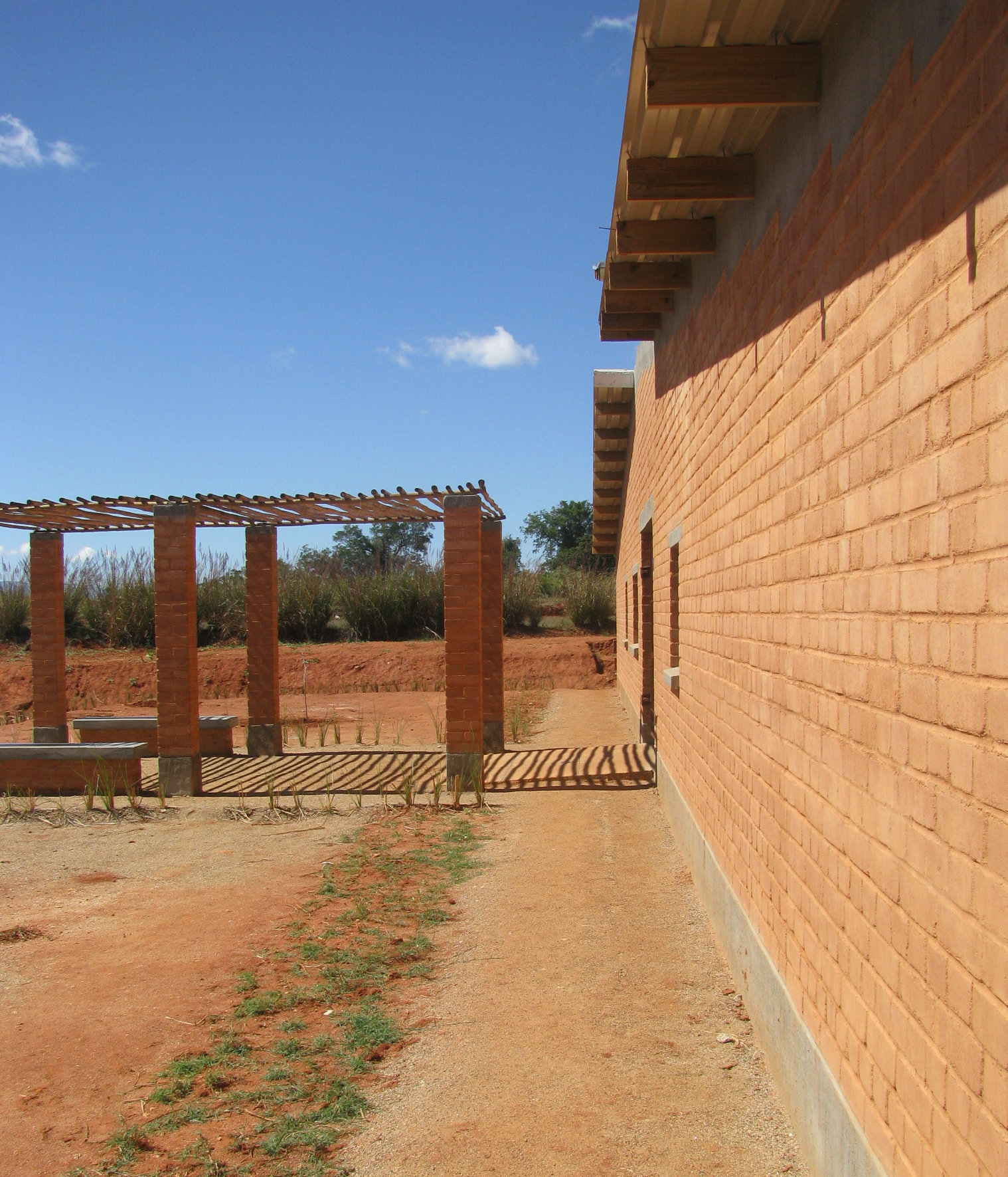 earthen red walls with pergola